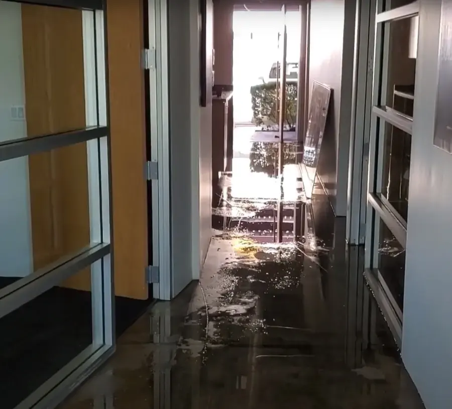 Water across a hallway floor in a South Gate apartment building