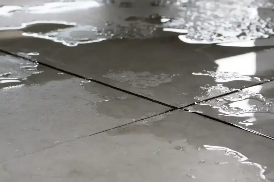 Water pooling on a concrete slab floor from a slab leak in South Gate