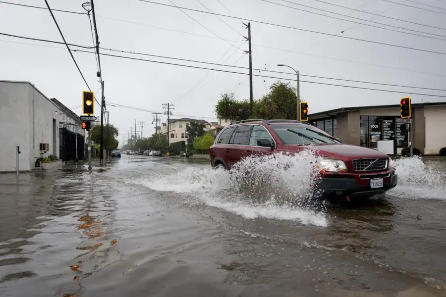 Storm water flooding a street during a heavy winter rain in South Gate