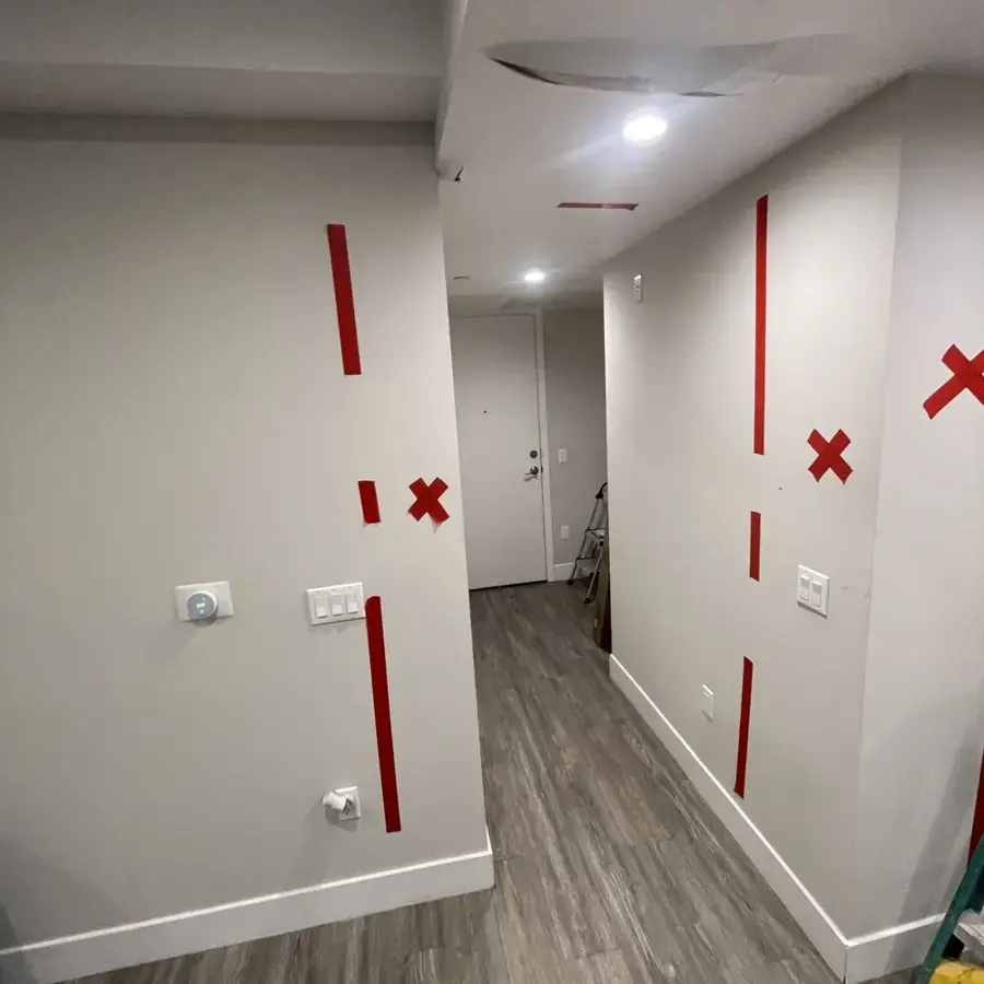 Flood-cut drywall marked for drying in a South Gate home